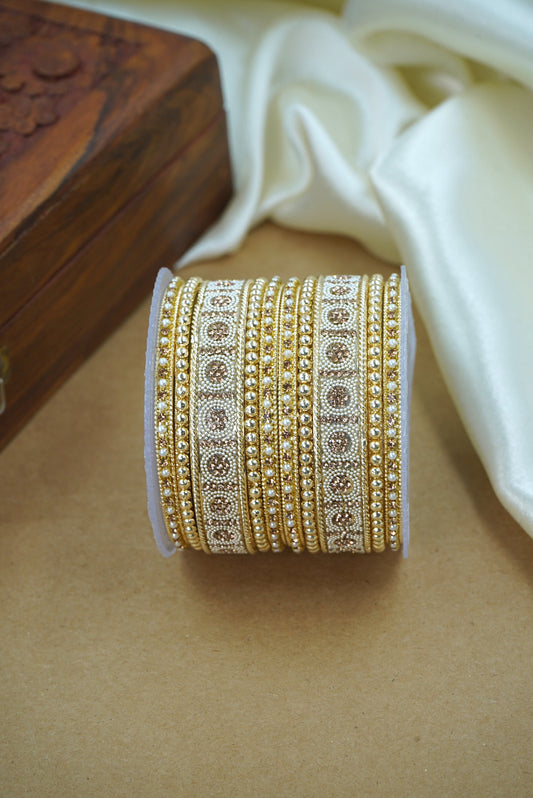 Decorative gold and white ribbon roll on a wooden surface by hitesh bangles