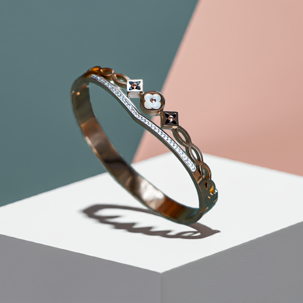 Gold bracelet with gemstones on a white surface by hitesh bangles