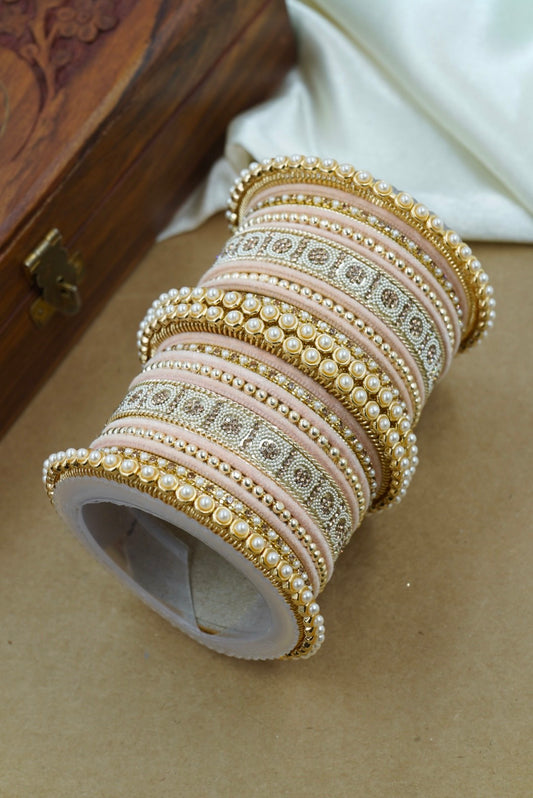 Set of decorative bangles on a textured surface with a wooden box in the background by hitesh bangles