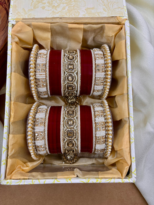 Pair of red and gold bangles in a decorative box by hitesh bangles