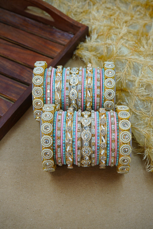 Set of colorful bangles with intricate designs on a textured surface by hitesh bangles