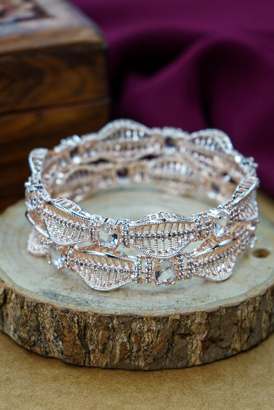 Silver bracelet on a wooden surface with a purple fabric background by hitesh bangles