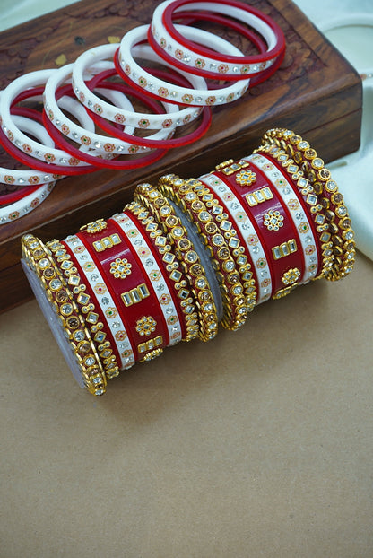 Decorative bangles with gold and red patterns on a wooden surface by hitesh bangles