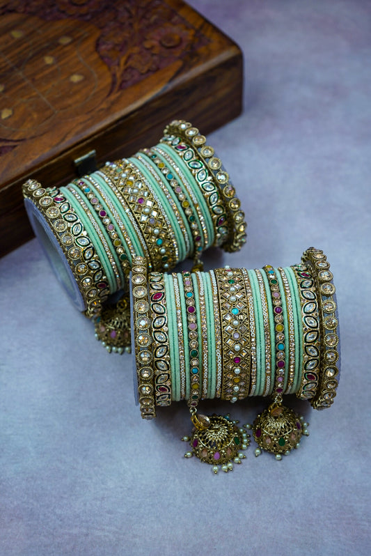 Decorative bangles with intricate designs on a textured surface by hitesh bangles