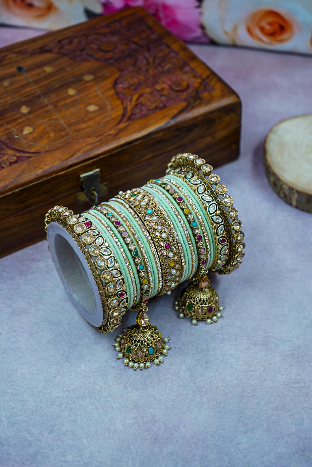 Decorative bangles with intricate designs on a light surface by hitesh bangles