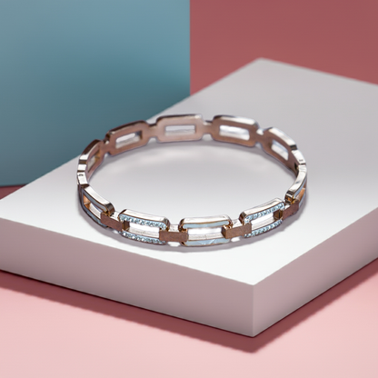 Silver bracelet with gemstones on a white platform with a pink and blue background by hitesh bangles