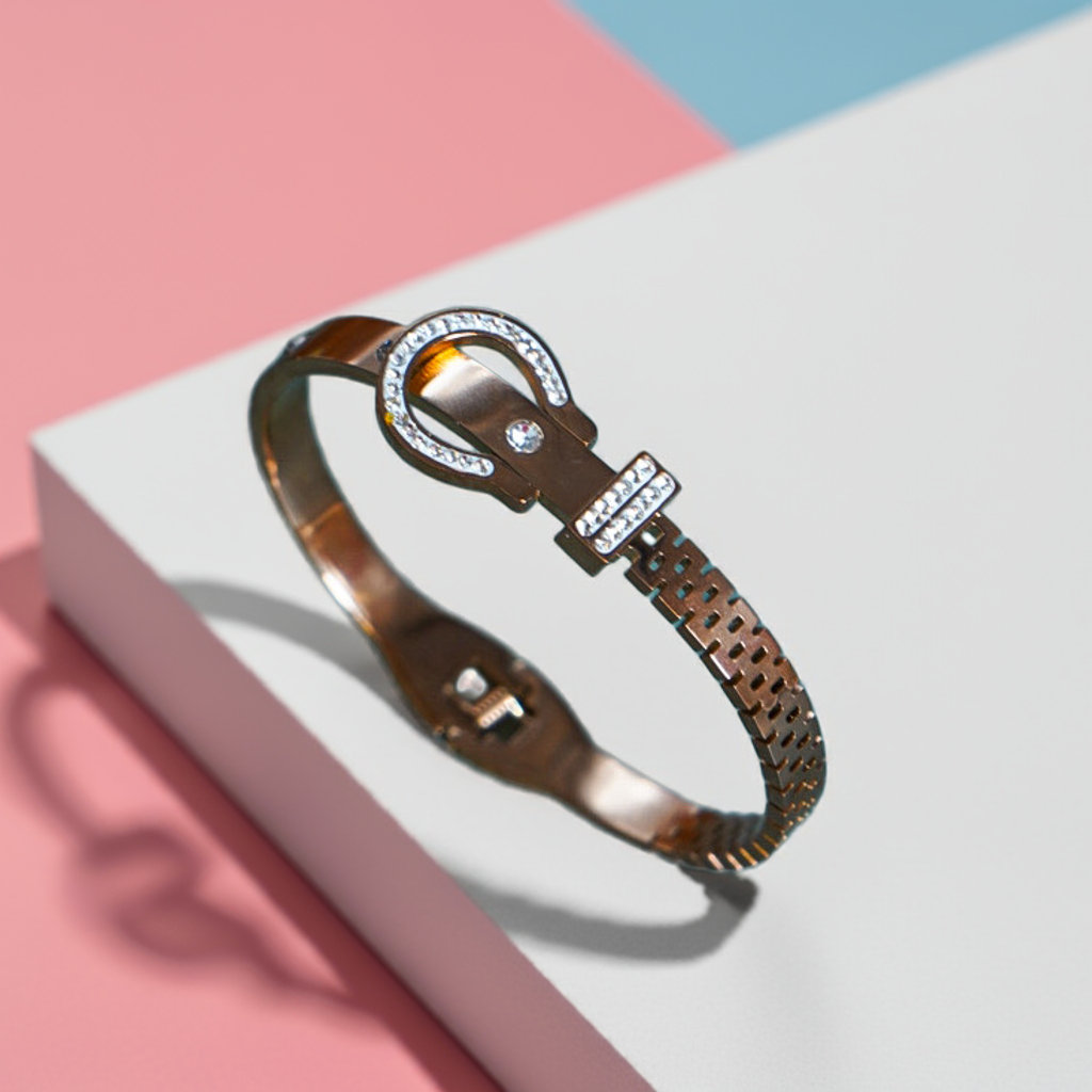 Bronze bracelet with intricate design on a white and pink background by hitesh bangles