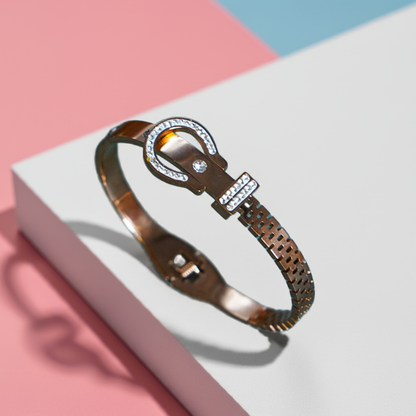 Bronze bracelet with intricate design on a white and pink background by hitesh bangles