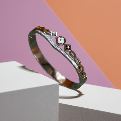 Gold bracelet with decorative elements on a geometric background by hitesh bangles