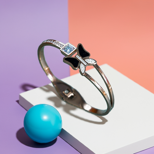 Silver bracelet with bow design on a colorful background by hitesh bangles