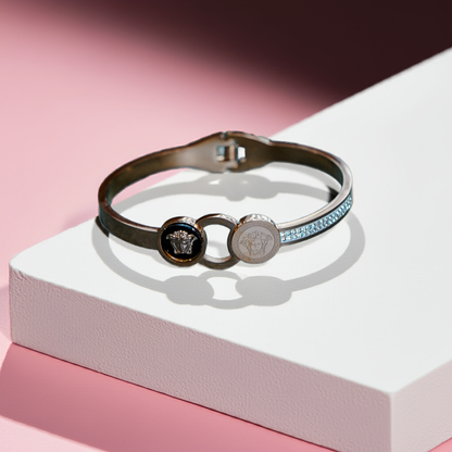 Multicolored bracelet with brand logo on a white and pink background by hitesh bangles