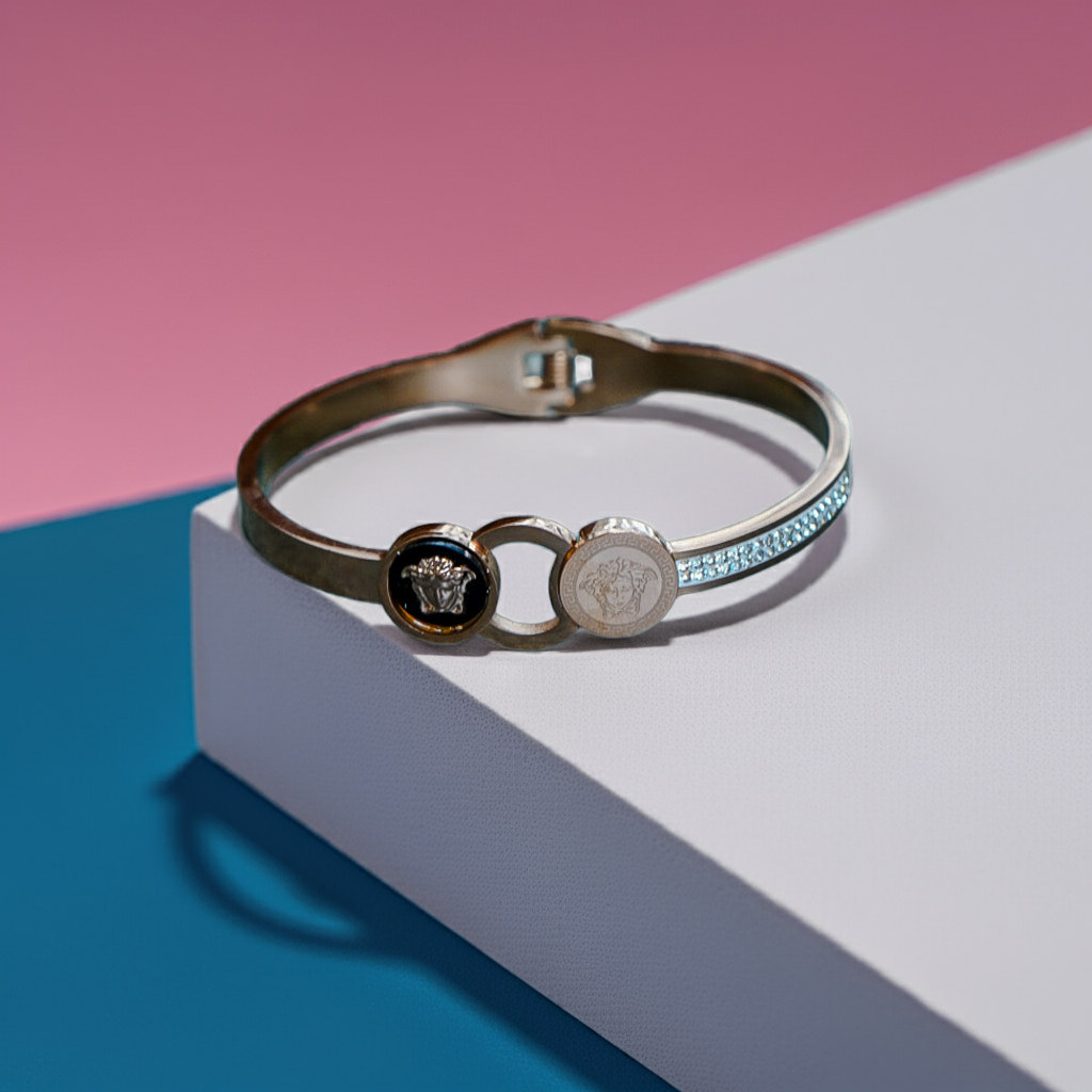 Silver bracelet with emblem design on a pink and blue background by hitesh bangles