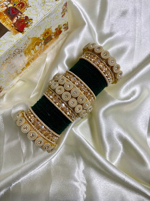 Green velvet bridal bangle set for women featuring intricate pearl and stone embellishments, designed by Hitesh Bangles, displayed on a satin backdrop with a decorative box in the background.