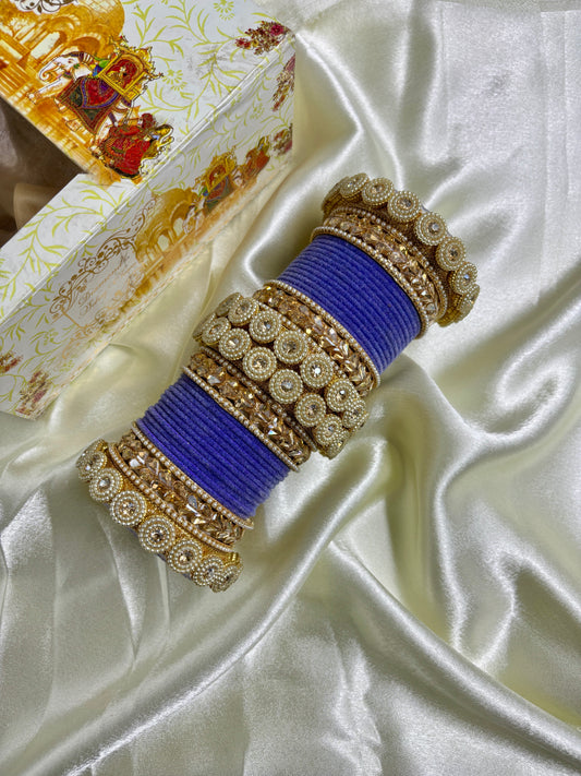 Decorative bangles with blue strings on a white satin background by hitesh bangles
