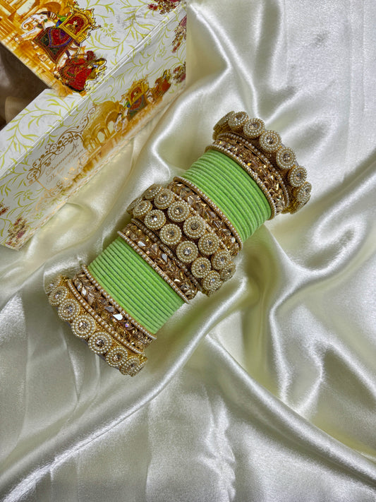 Decorative green and gold bracelet on a satin surface by hitesh bangles