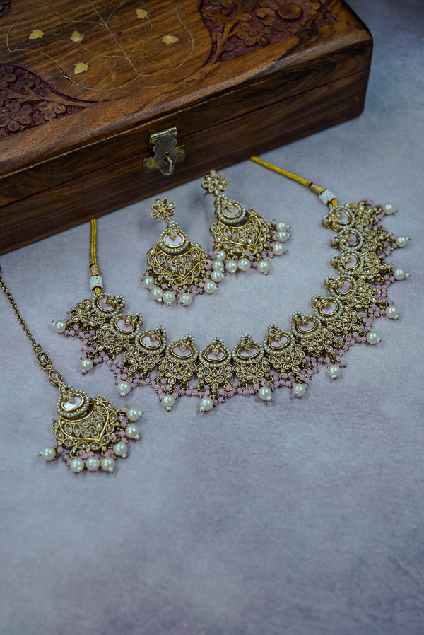 Gold and pearl jewelry set with a wooden box on a gray background by hitesh bangles