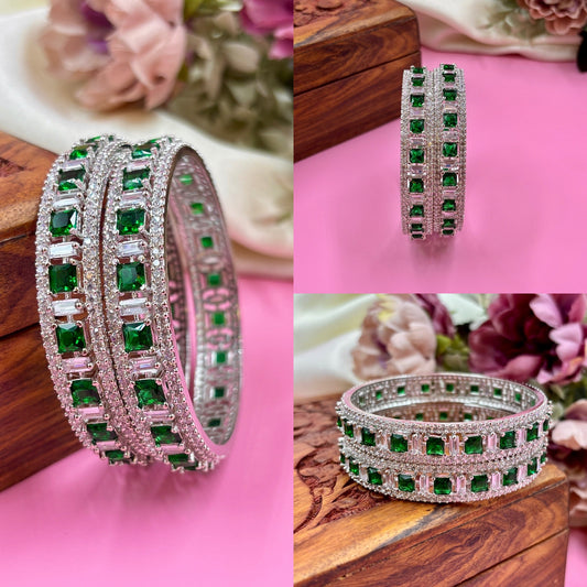 Collage of green gemstone bangles on a pink fabric background with floral elements by hitesh bangles