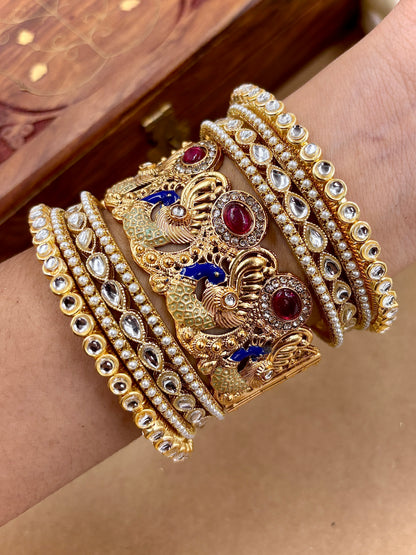 Gold and diamond bracelet on a wrist with a wooden box in the background by hitesh bangles