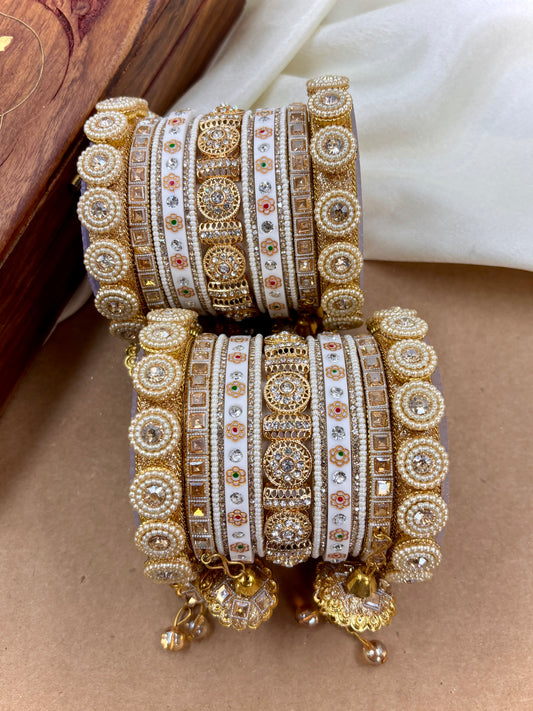 Decorative bangles with intricate designs on a wooden surface by hitesh banglee