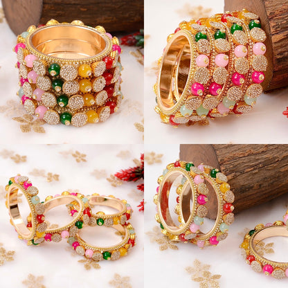 Set of colorful bangles with gold accents on a floral background by hitesh bangles
