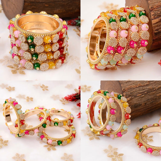Set of colorful bangles with gold accents on a floral background by hitesh bangles