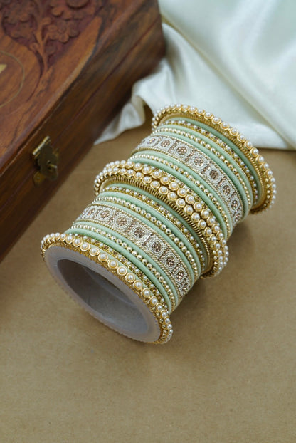 Roll of decorative ribbons with intricate patterns on a wooden surface by hitesh bangles