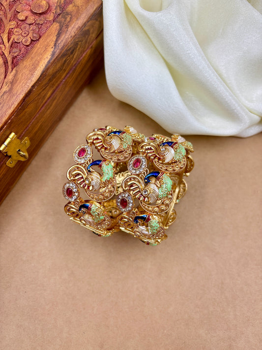 Decorative brooch with gemstones on a beige surface next to a wooden box and white fabric by hitesh bangles