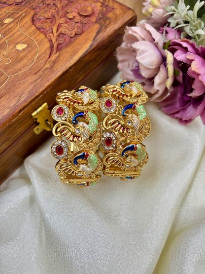 Gold jewelry piece with gemstones on a white fabric background by hitesh bangles