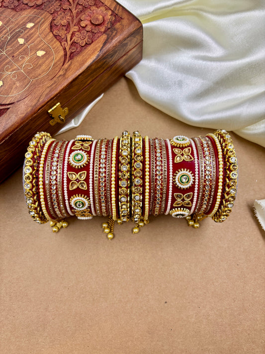 Decorative bangles with intricate designs on a beige surface by hitesh bangles