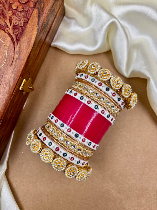 Decorative bangles with intricate designs on a beige surface by hitesh bangles