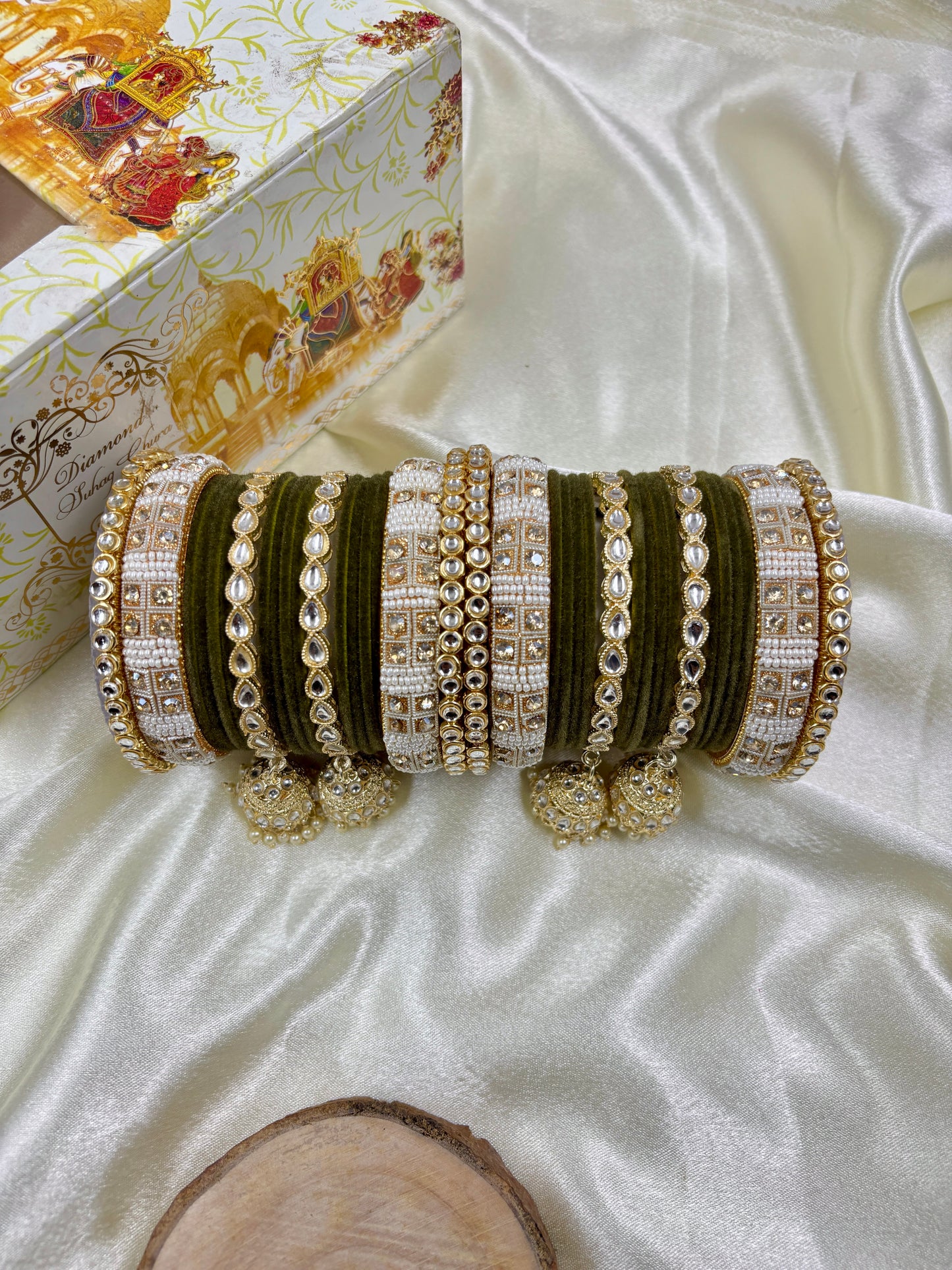 Set of decorative bangles on a white fabric background by hitesh bangles