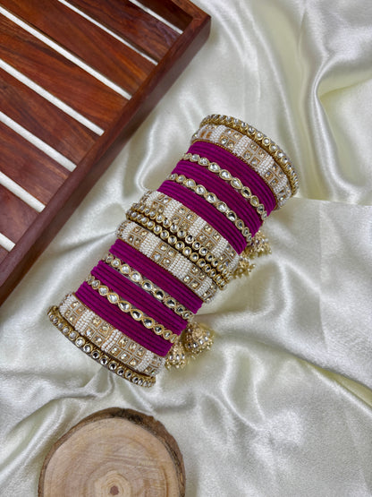 Elegant Red Velvet Bridal Chuda Set by Hitesh Bangles featuring Kundan work, pearl detailing, and golden jhumkis, displayed on ivory satin fabric with a wooden tray and decorative background by hitesh bangles


