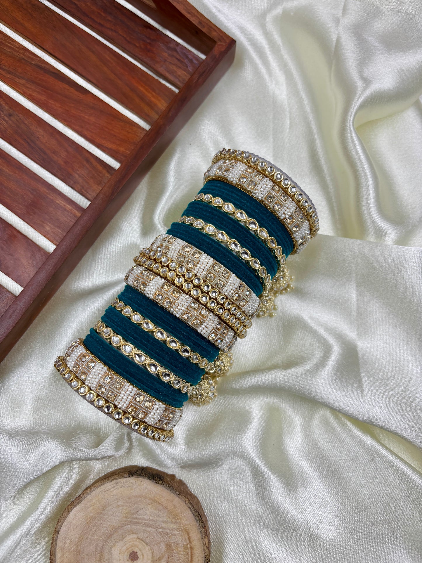 Set of blue and gold bangles on a white fabric background by hitesh bangles