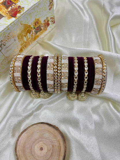 Set of decorative bangles on a white fabric background by hitesh bangles