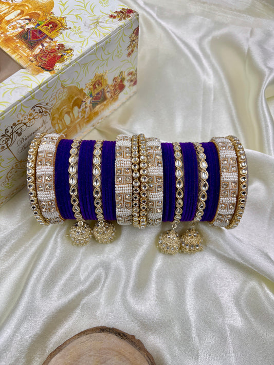 Decorative clutch with blue and gold accents on a white satin surface by hitesh bangles