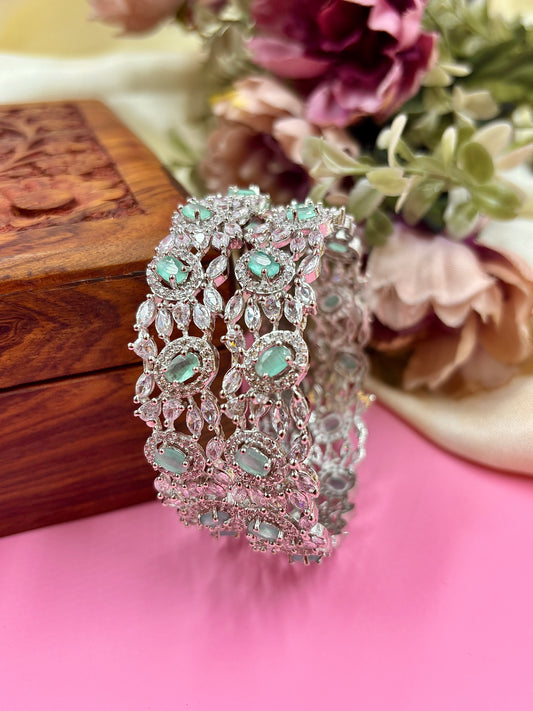 Decorative headband with gemstones on a pink surface with flowers in the background by hitesh bangles