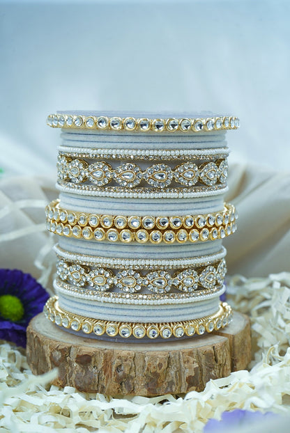Stack of decorative bracelets on a wooden block with a soft blurred background by hitesh bangles