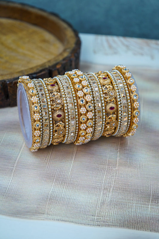 Set of gold and silver bangles on a textured surface with a blurred background by hitesh bangles