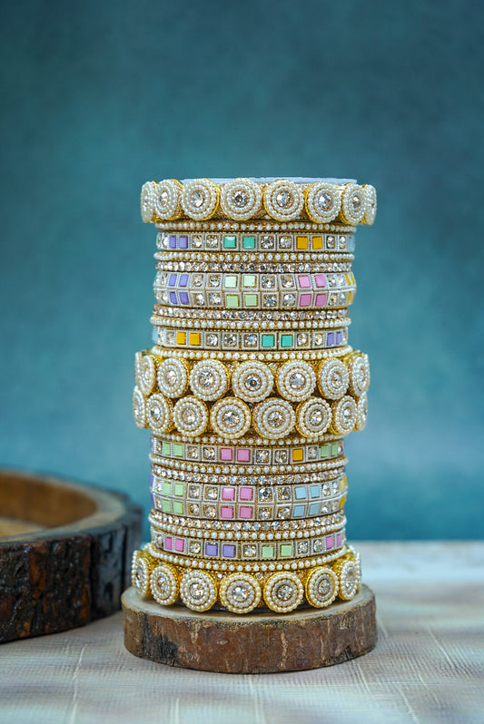Stack of colorful bangles on a wooden stand with a blue background by hitesh bangles
