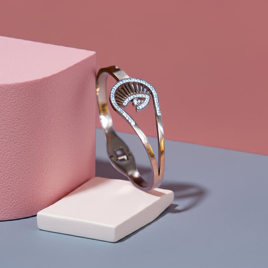 Silver bracelet on a white stand against a pink and gray background by hitesh bangles