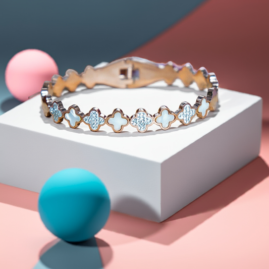 Bracelet with star-shaped charms on a white platform with colorful background by hitesh bangles