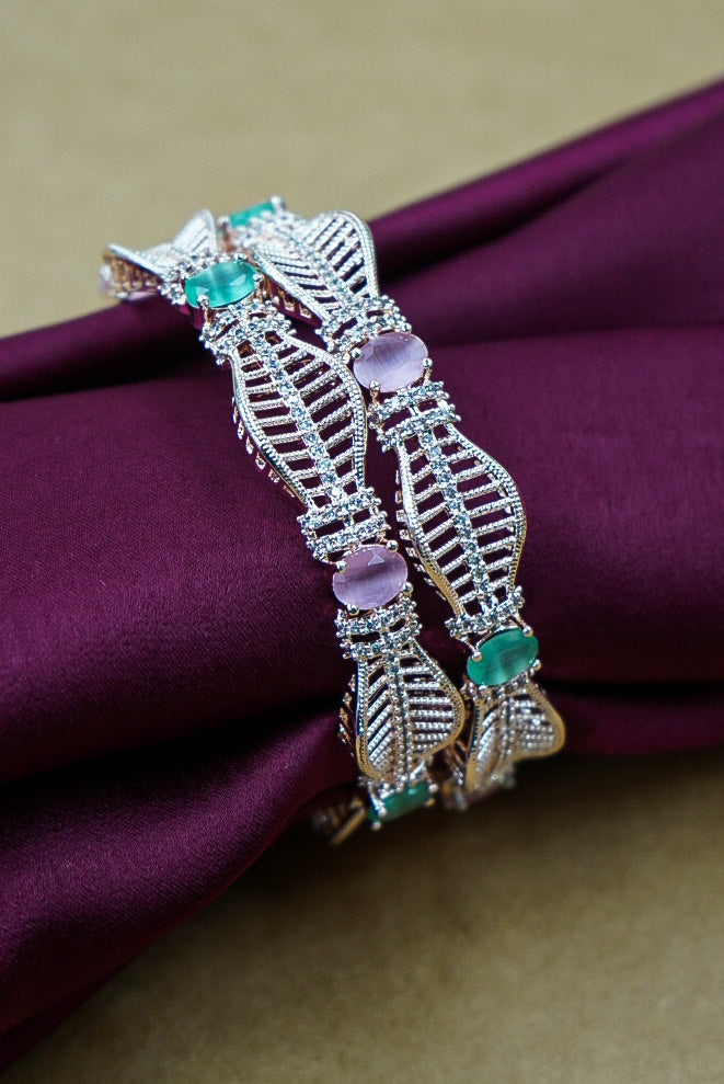 Decorative brooch with gemstones on a purple fabric background by hitesh bangles