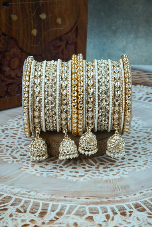 Set of decorative bangles with jhumka earrings on a wooden surface by hitesh bangles