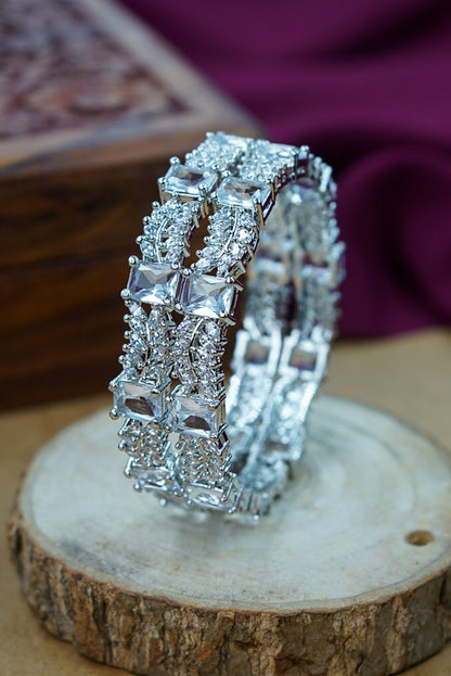 Silver bracelet with diamond accents on a wooden surface by hitesh bangles