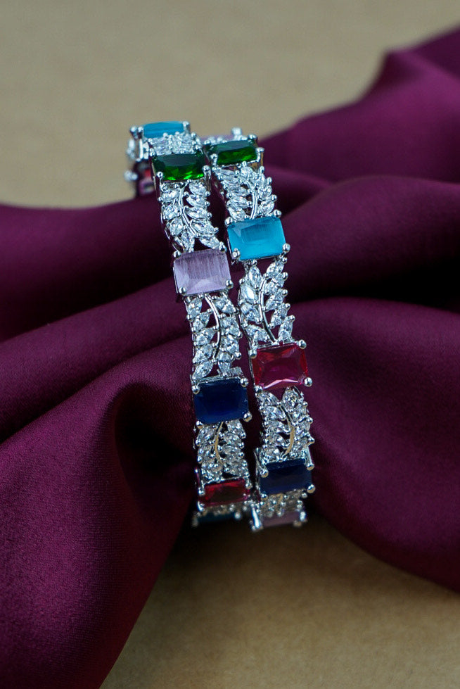 Decorative bracelet with colorful gemstones on a purple fabric background by hitesh bangles