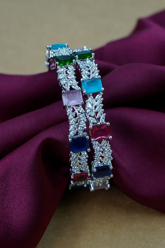 Decorative bracelet with colorful gemstones on a purple fabric background by hitesh bangles