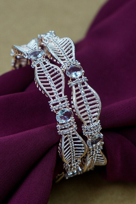 Decorative brooch with gemstones on a purple fabric background by hitesh bangles