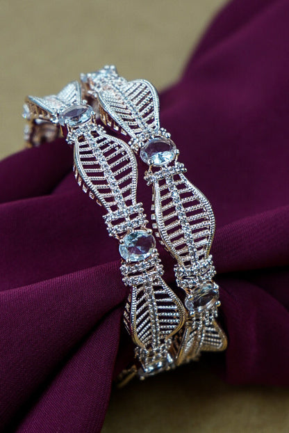 Decorative brooch with gemstones on a purple fabric background by hitesh bangles