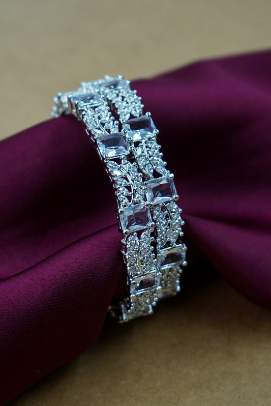 Silver bracelet with gemstones on a purple fabric background by hitesh bangles