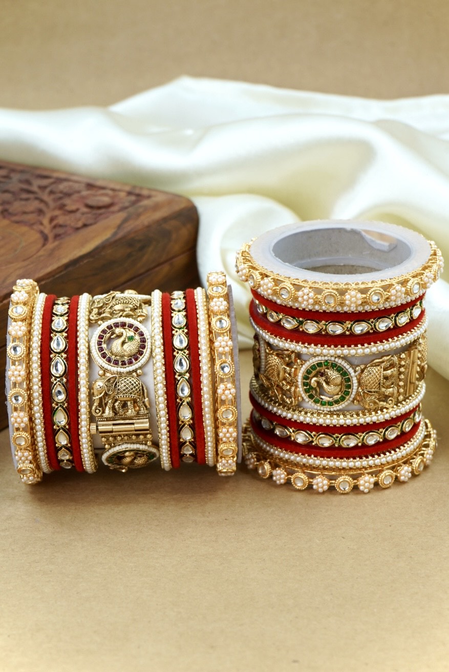 Decorative bangles with intricate designs on a beige surface by hitesh bangles
